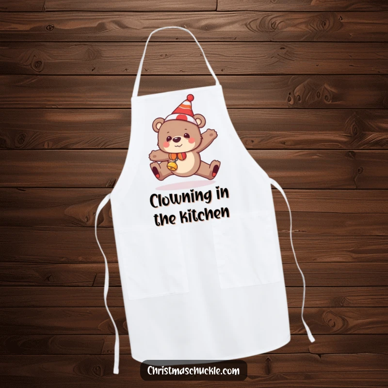 Funny bear apron depicting a festive bear in a clown hat and bells, humorously tripping while cooking.