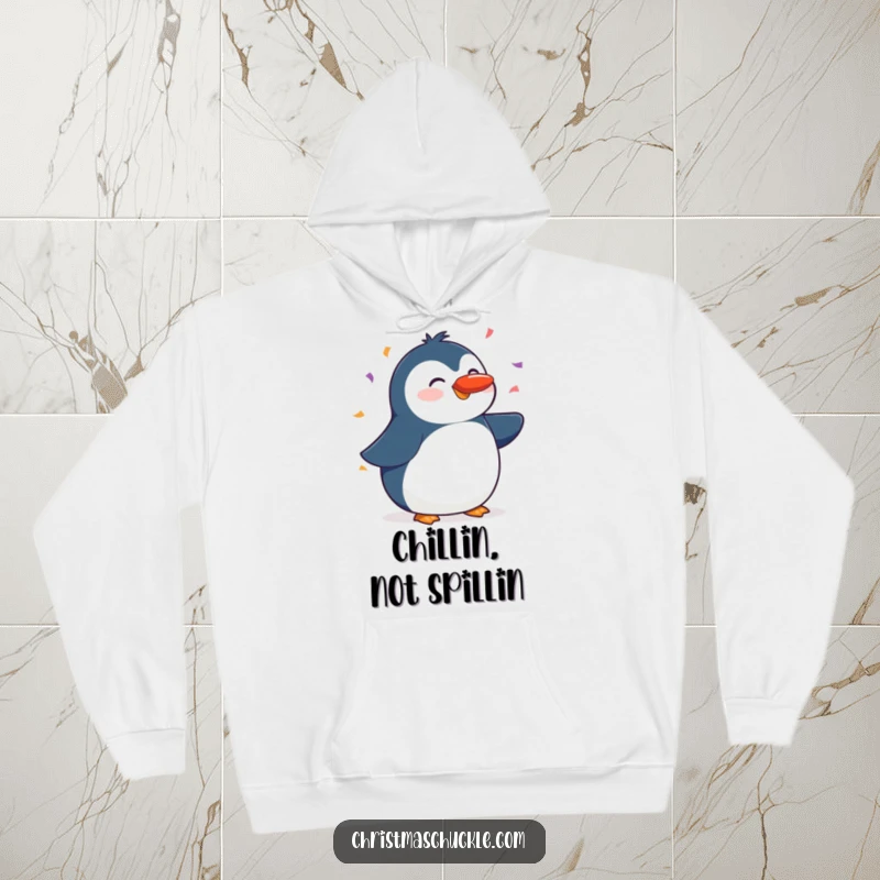 Funny hoodie with a cheerful penguin balancing a red nose on its beak, with a festive shower of confetti, cozy winter attire.