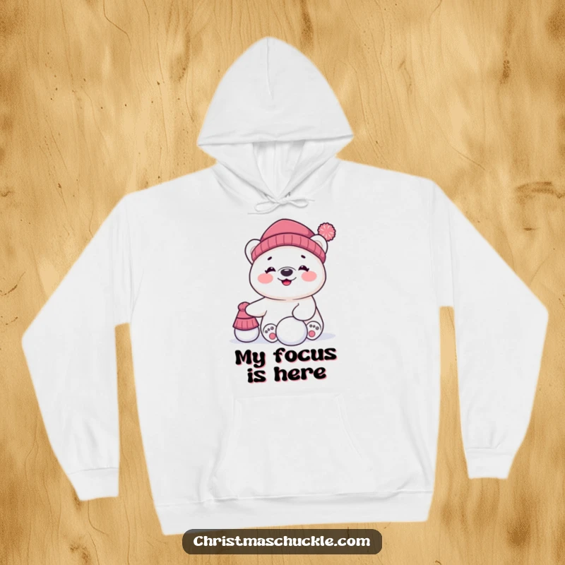Funny hoodie depicting a giggling polar bear character comically attempting to balance a hat atop its head and a snowball, pure arctic fun.