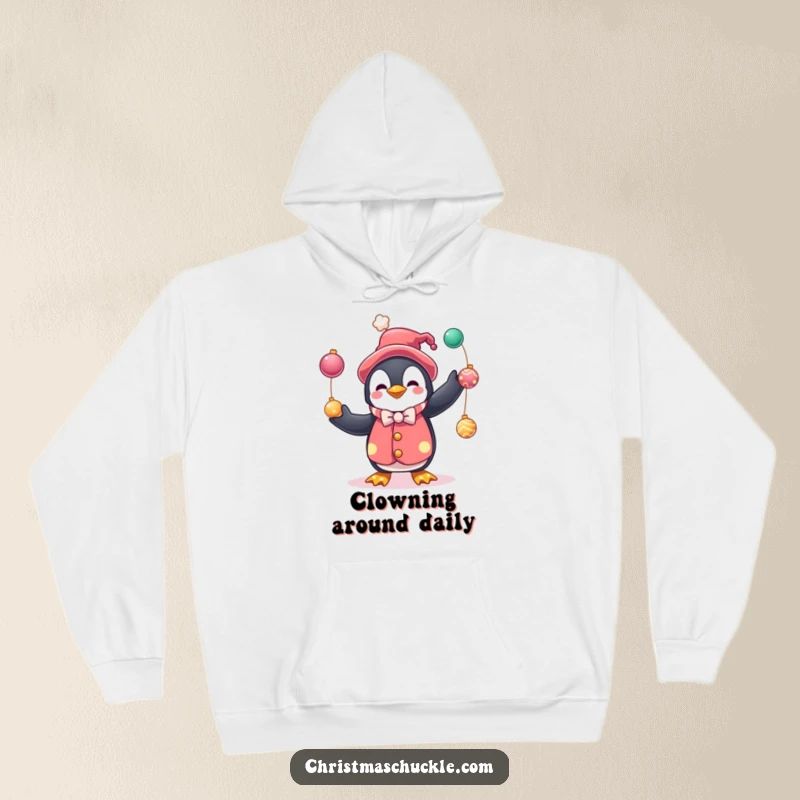 Funny hoodie featuring a charming penguin dressed as a clown, juggling festive baubles, ideal for holiday comfort and humorous style.
