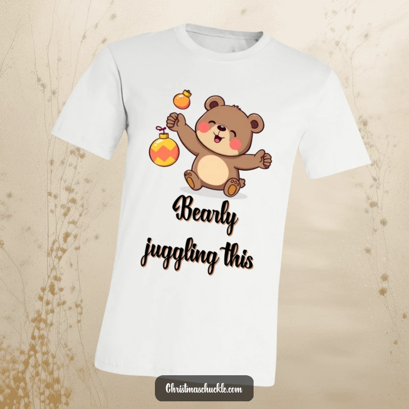 Funny t-shirt print of a happy bear character clumsily juggling three brightly colored holiday ornaments with a determined expression.